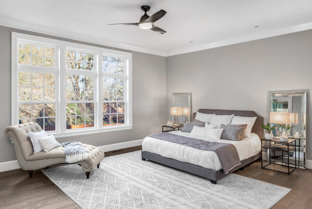 Freshly made bed in a bright, tidy bedroom after an Airbnb turnover cleaning