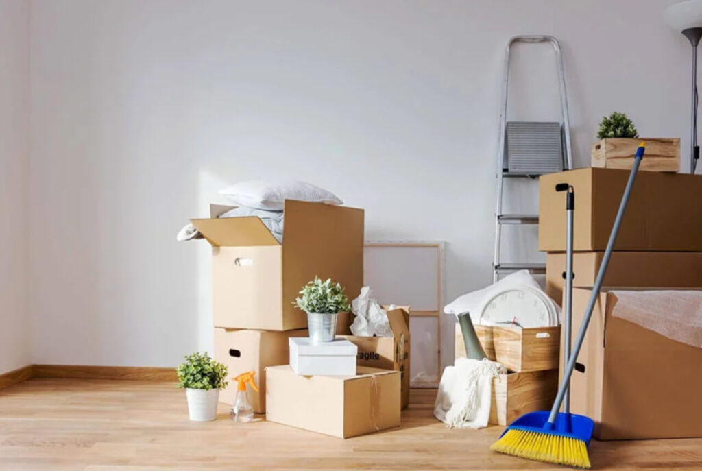 Moving boxes and cleaning supplies in an empty room ready for a move-out cleaning